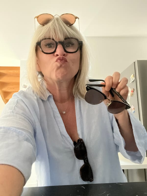 Woman packs suitcase, takes selfies while preparing for travel