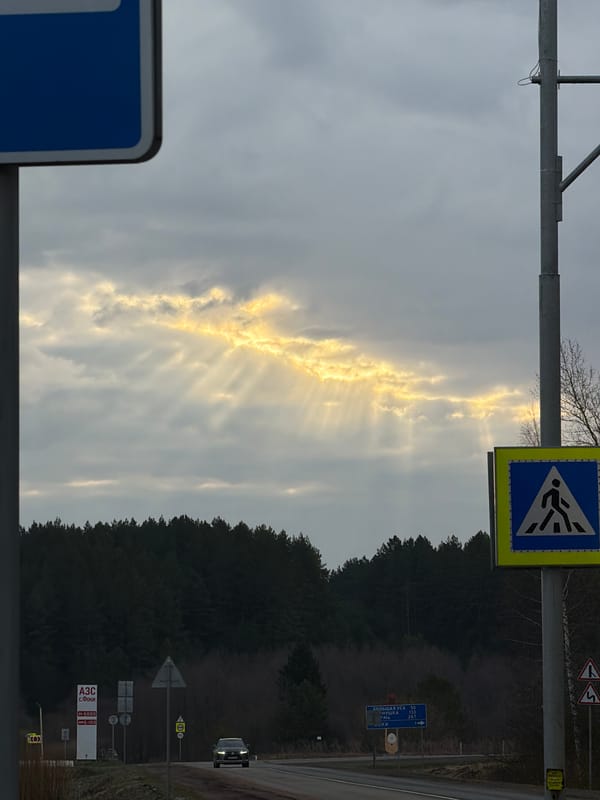 Dramatic sunrise illuminates cloudy skies over Rusalevka roadside