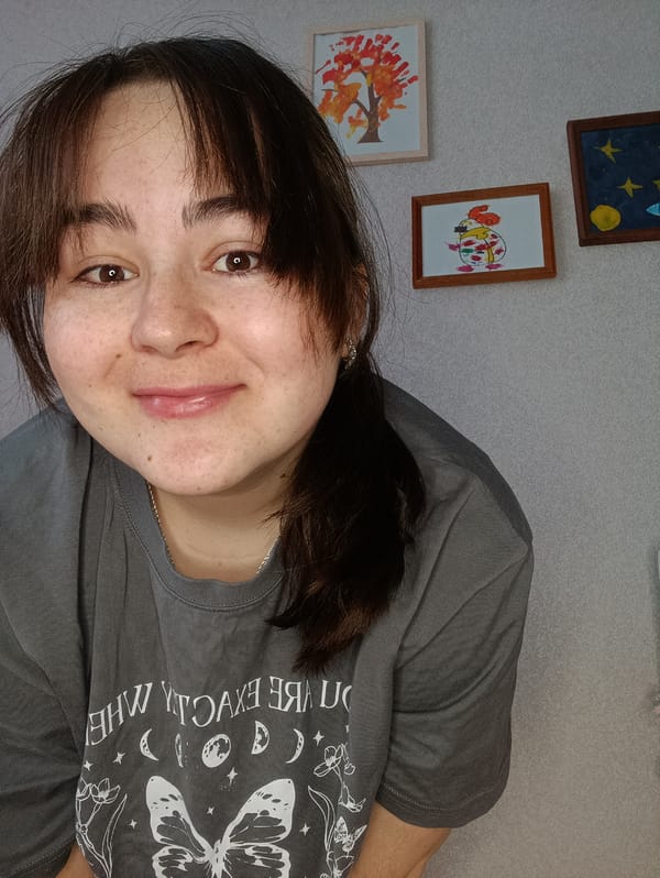 Woman reads Russian book, holds baby in early morning