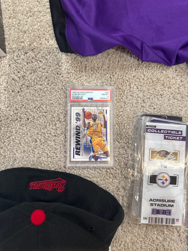 Sports memorabilia and personal items arranged on carpet in Aventura