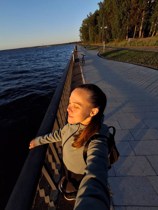 Woman documents leisurely day at Kama River waterfront in Russia