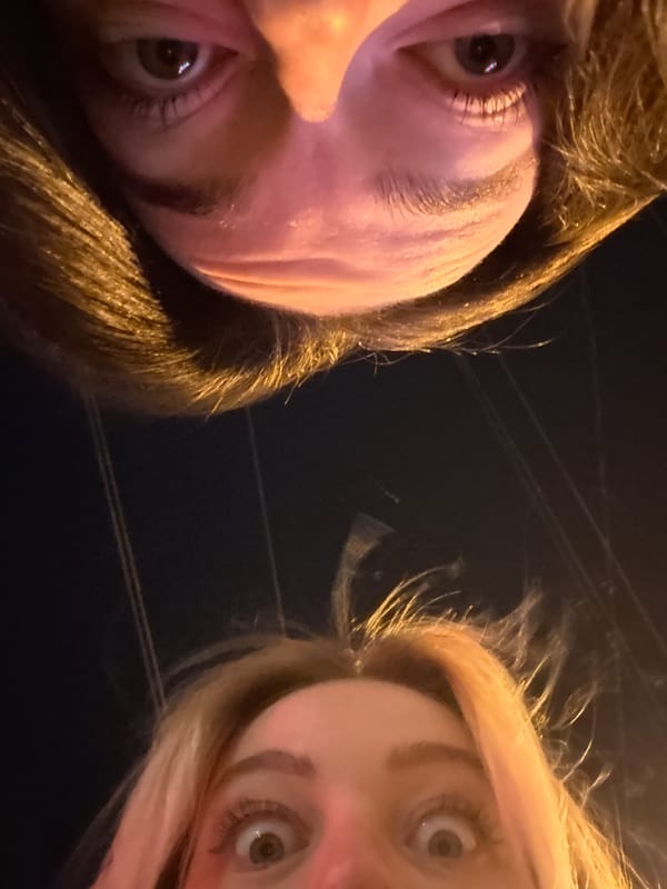 Women take selfies on sidewalk in Krasnoyarsk