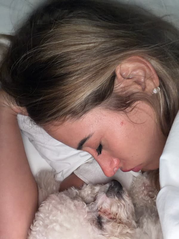 Woman and white dog share afternoon nap in Kedewatan