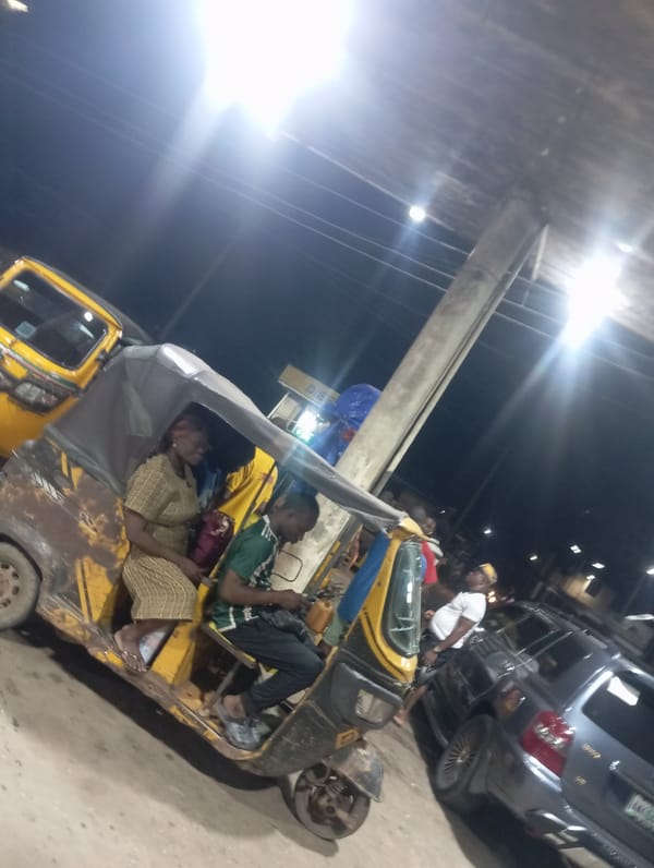 Night scene shows Keke Napep and SUV in Nkpor