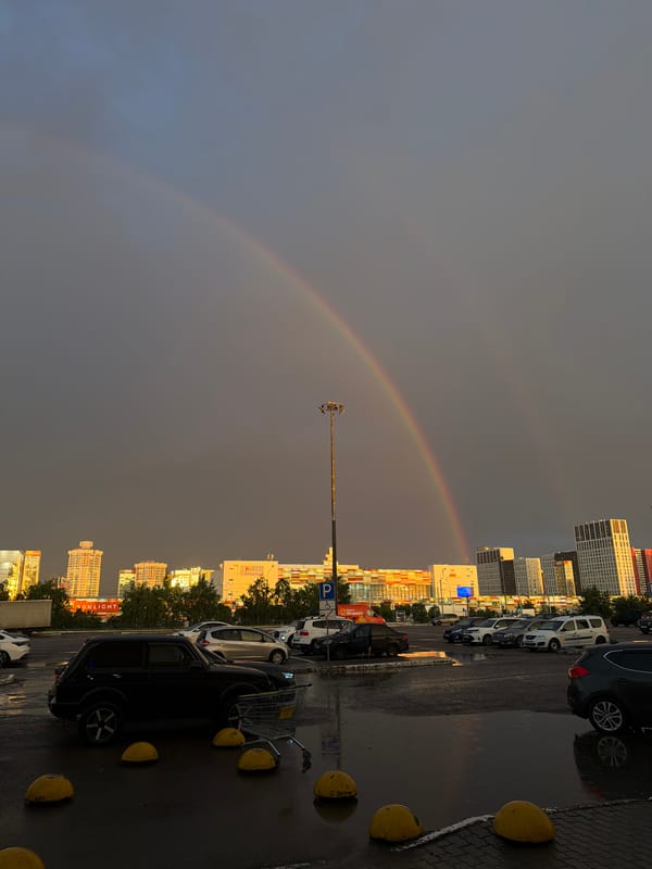Double rainbow over a rainy Krasnoyarsk parking lot