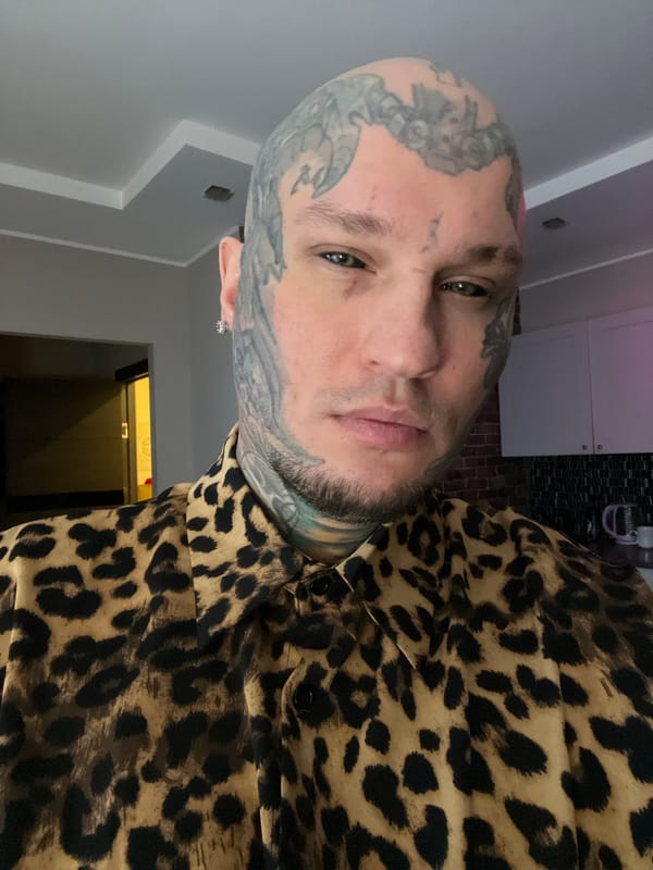 Tattooed man photographed in selfie portraits in Kudrovo, Russia