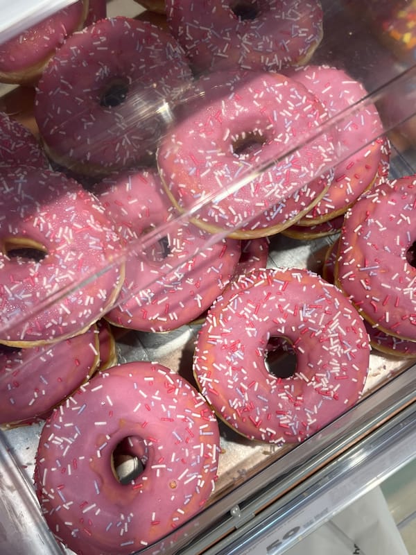 Pink-frosted doughnuts displayed in Oktyabrsky bakery case