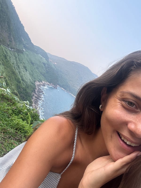 Woman photographs coastal mountain scenery in Đà Nẵng Vietnam