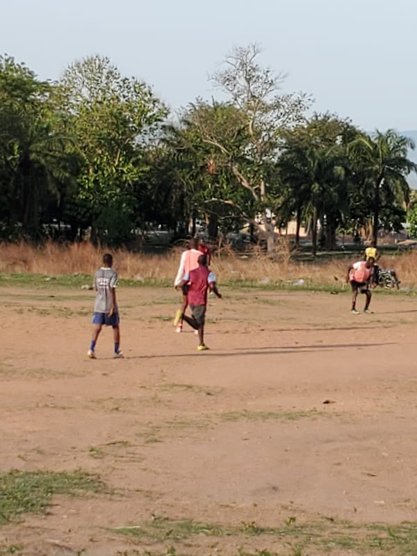 Soccer game played on dirt field in Mararaba