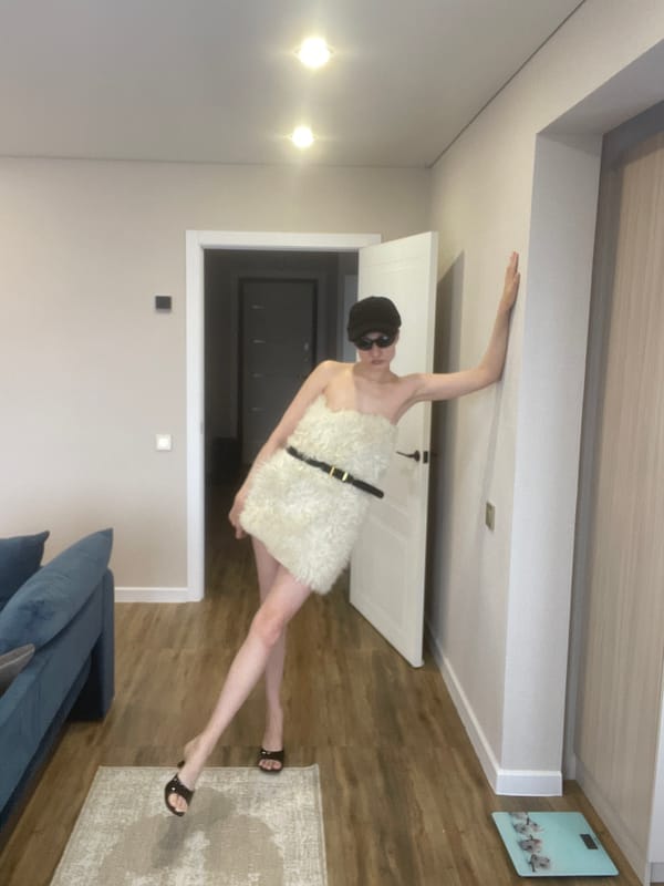 Masked figure in white garment spotted against wall