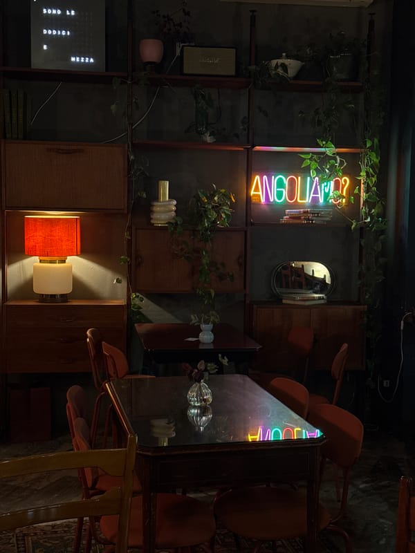 Milan establishment captured with warm lighting, vintage-modern decor blend