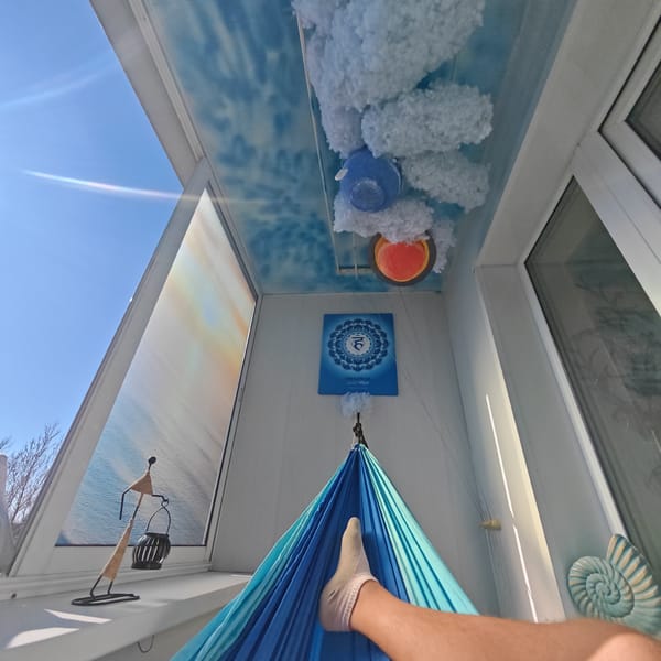 Person enjoys lazy Sunday morning in hammock, Rostov balcony