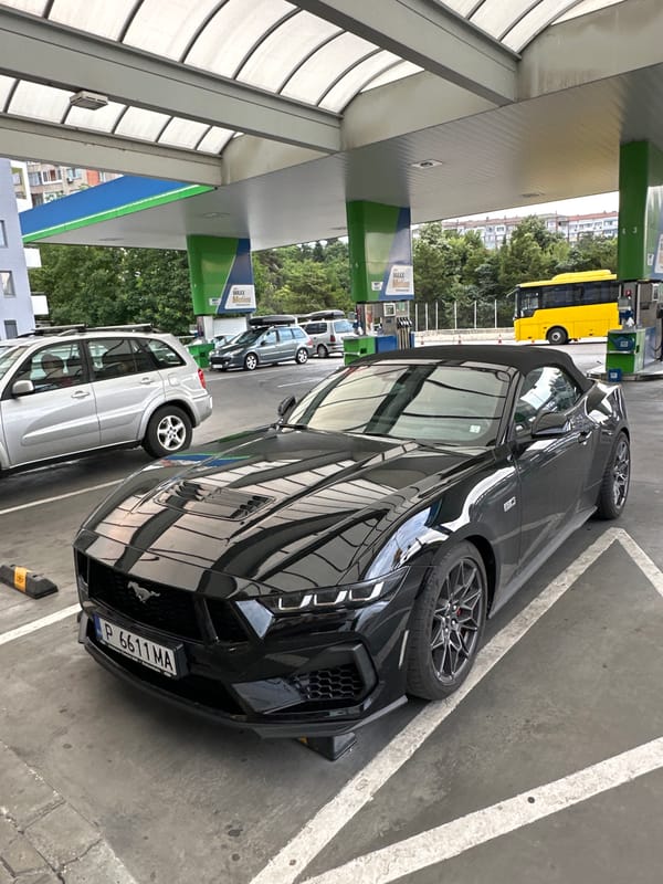 Black Mustang GT cruises through Veliko Tarnovo midday traffic