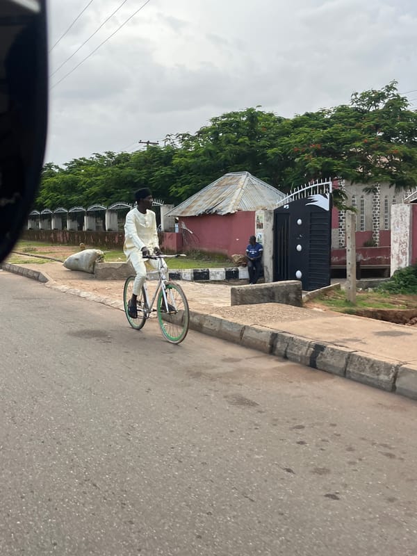 Street life and retail interiors across an evening in Bukuru, Nigeria