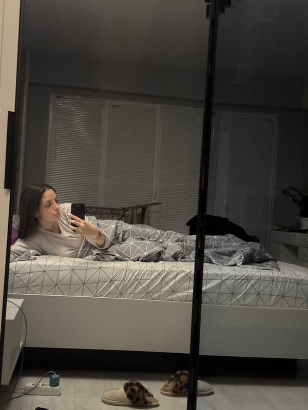 Woman with phone in bedroom captured in Sofia