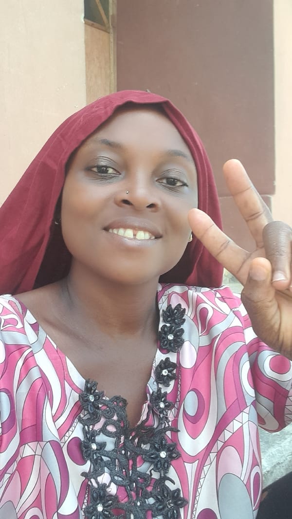 Woman does laundry, poses for photos in Ado courtyard