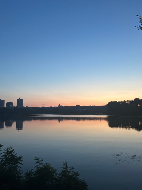 Sunset and moonrise over the Dnipro River, summer evening