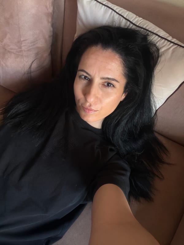 Woman takes selfies on pink couch in Pleven