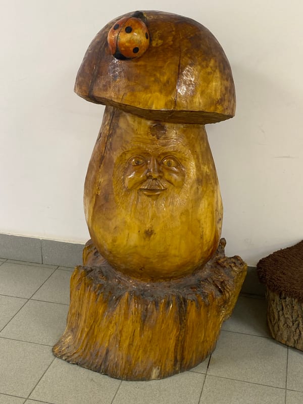 Large carved wooden sculpture with human face documented