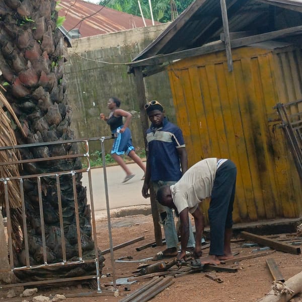 Two men conduct street metalwork in Akwanga, Nigeria