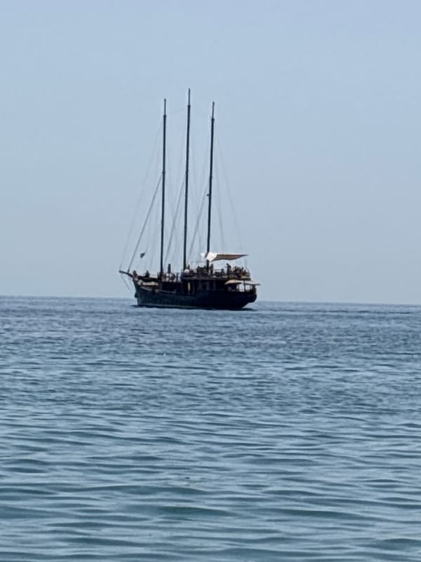 Three-masted tour sailboat cruising calm waters off southern Spain