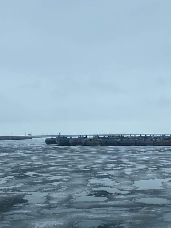 Ships docked at frozen pier in Chaikovsky, Russia