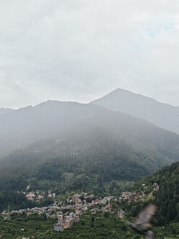 Misty morning in Vashisht: river, mountains, and town in focus