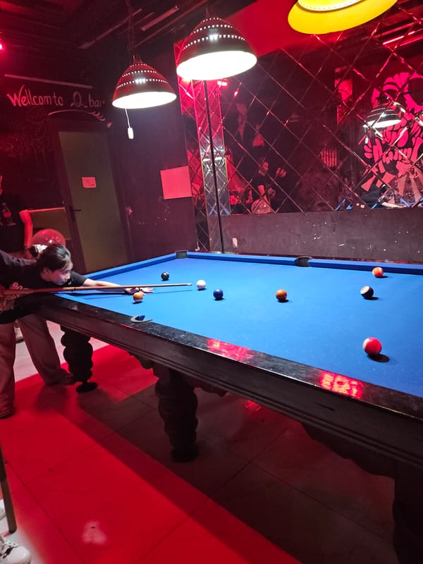 Pool game captured at red-lit Nha Trang establishment