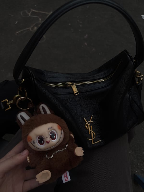 YSL handbag photographed on lap in Lyubertsy, Russia