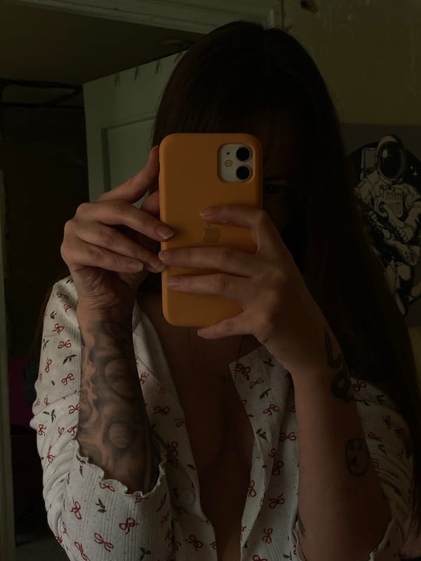 Woman takes mirror selfie with orange phone in Votkinsk