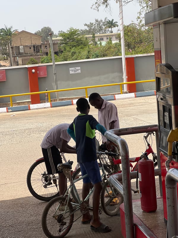 Two cyclists visit petrol station in Jos, Nigeria