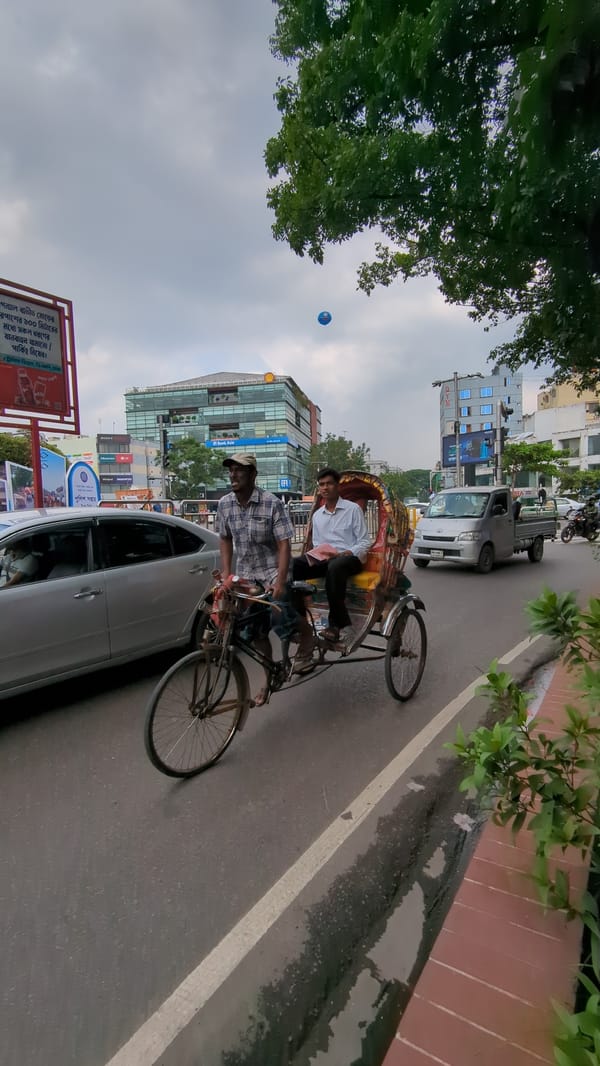 Morning traffic flows through Dhaka streets amid urban activity