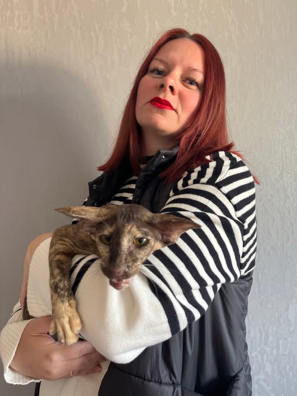 Woman with red hair holds Oriental cat in Chaikovsky