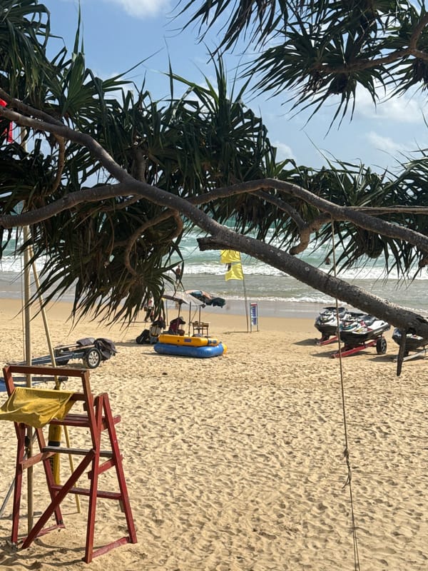 Sunny morning at Karon Beach, parasail in the sky
