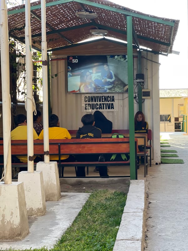 Young people gather at outdoor seating area in Arica