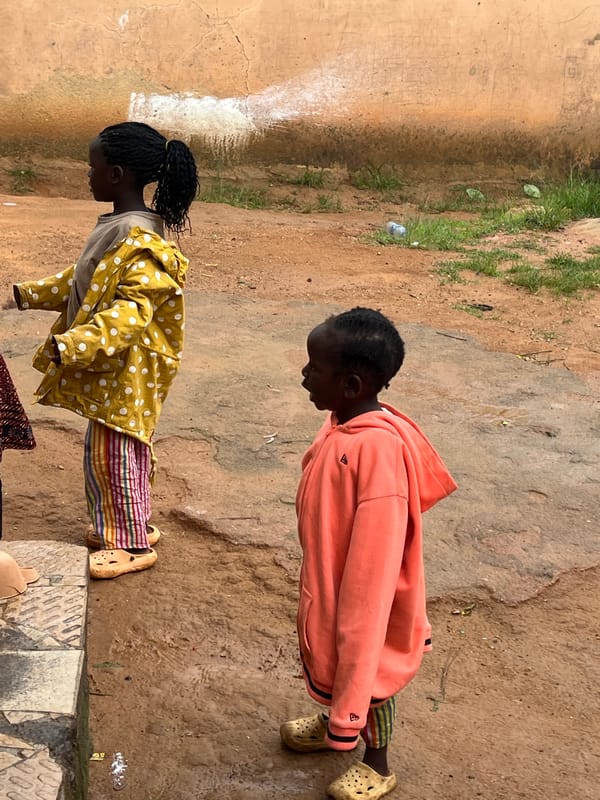 Kids playing outdoors in a residential yard in Jos, Nigeria