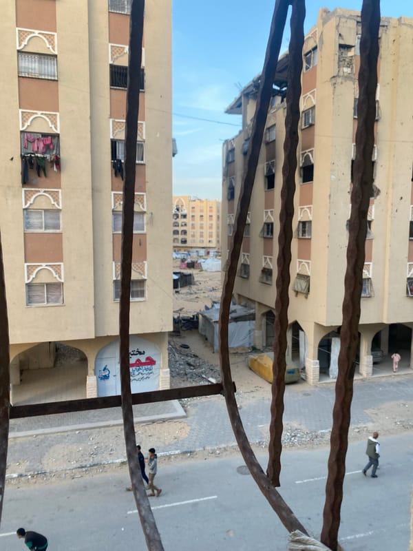 Street scene shows damaged buildings in Khan Yunis