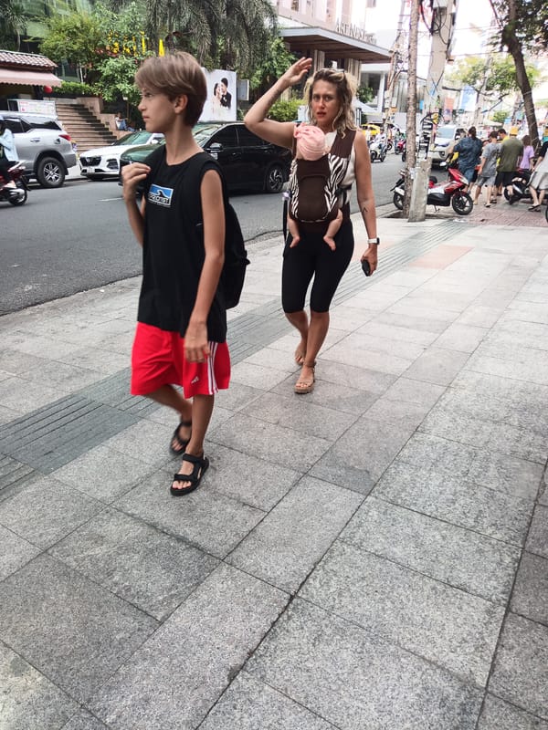 Busy sidewalk life on a Nha Trang street, July morning