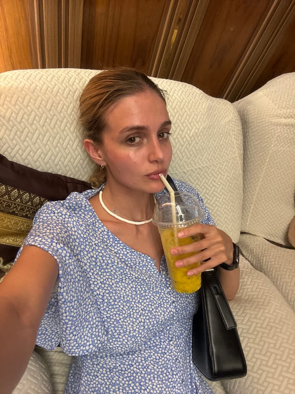 Woman relaxes with drink on sofa in Patong