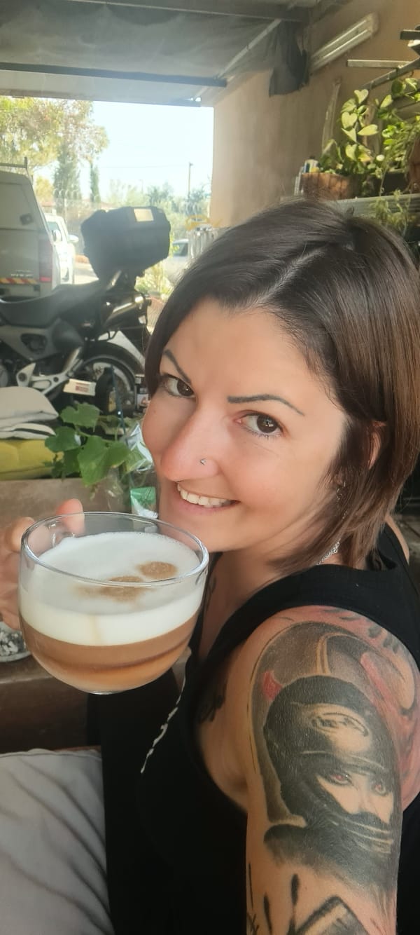 Woman enjoys layered coffee drink in Israeli regional area