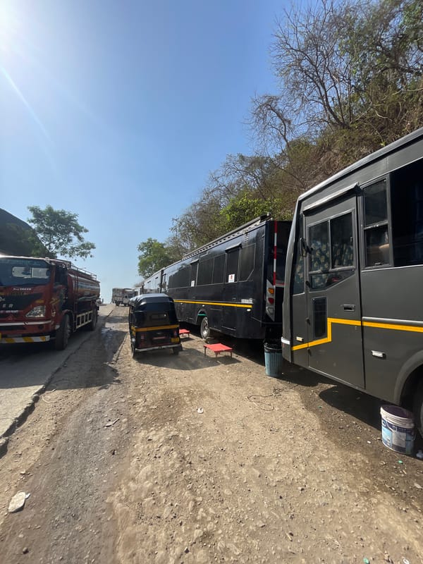 Buses with yellow stripes parked on Mumbai street