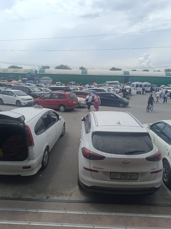 Busy urban morning: street work, market activity, and vehicles