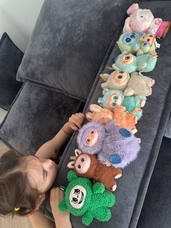 Child rests with plush toys on sofa in Kharnavy