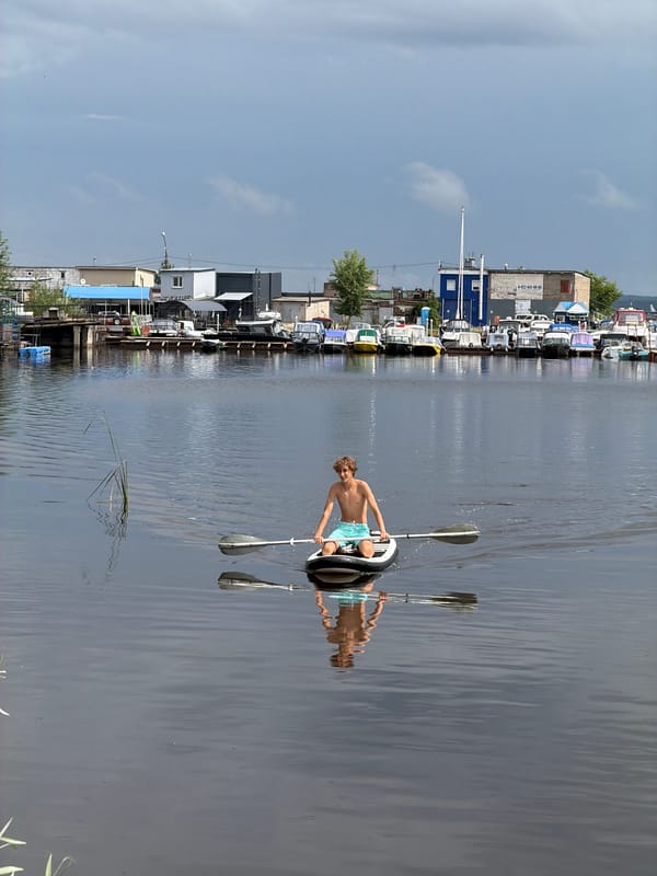 Paddleboarding on calm marina water in Chaikovsky, Russia