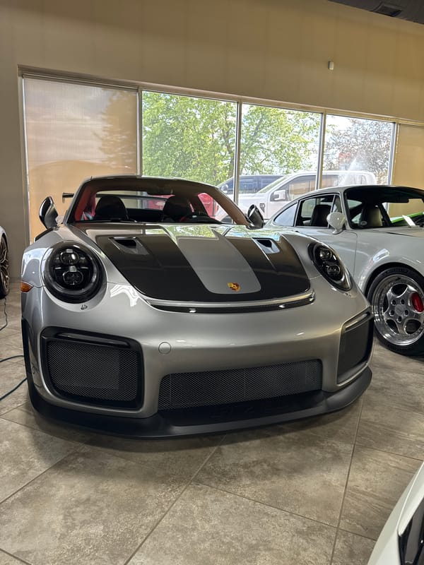 Luxury car dealership showcases Porsche, Ferrari, Lamborghini collection