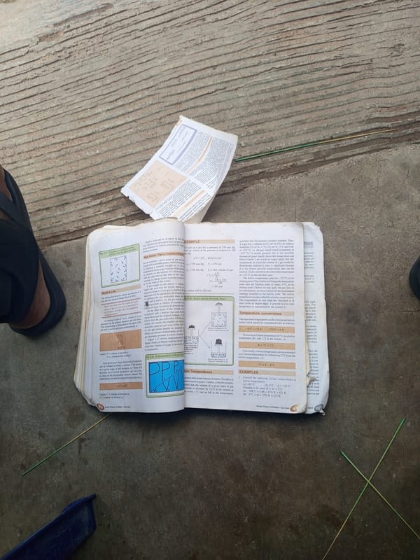 Outdoor textbook study session in Jalingo covers microbiology