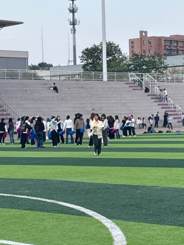 Group gathers at Linghe stadium, women observe sky
