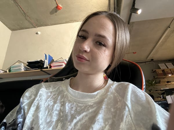 Multiple selfies in an industrial office space, same session.