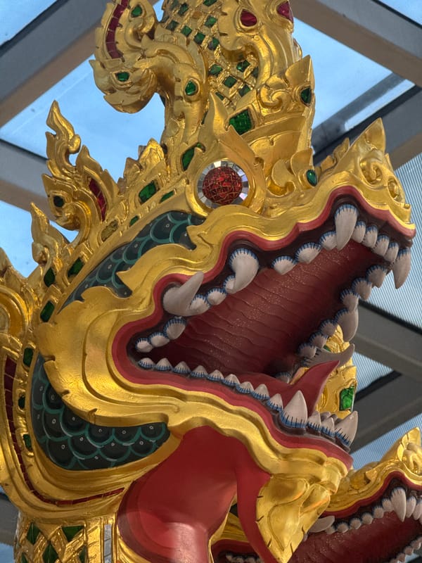 Luxury storefronts and mythological sculptures at Suvarnabhumi Airport