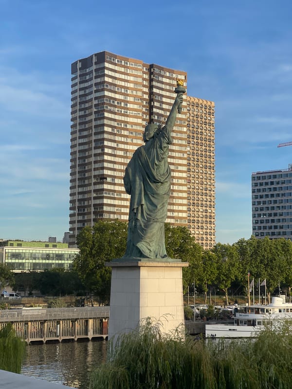 Seine riverbank at sunset, Liberty replica and city views